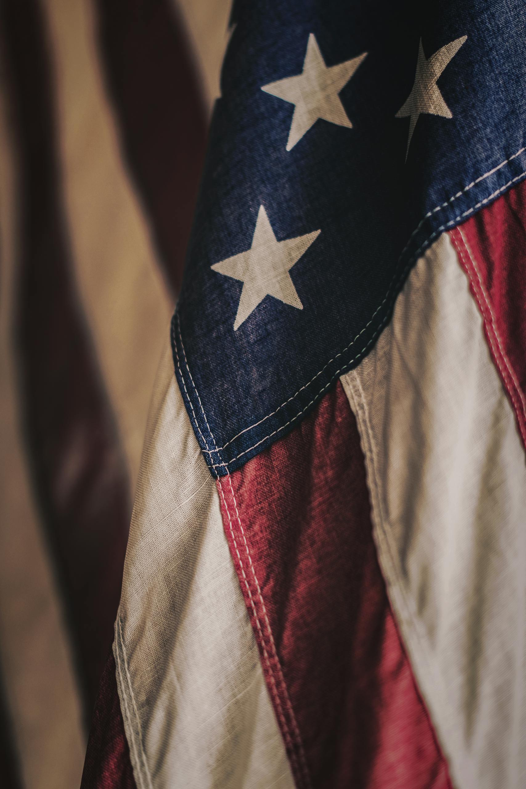 Detailed texture of the American flag fabric highlighting its stars and stripes.