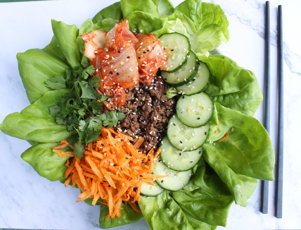 fermented kimchi meal with lettuce, cucumbers, carrots, beef, and cucumbers