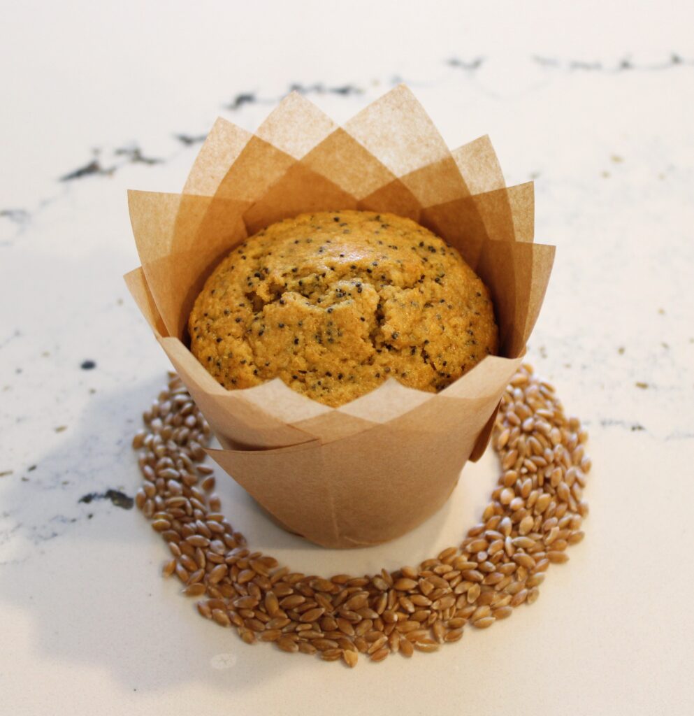 fresh milled lemon poppyseed muffins with wheat berries in a circle around the muffin.