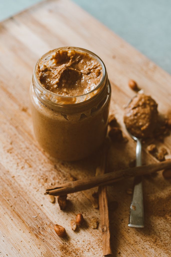 Delicious homemade peanut butter with cinnamon on a board, perfect for keto diet.